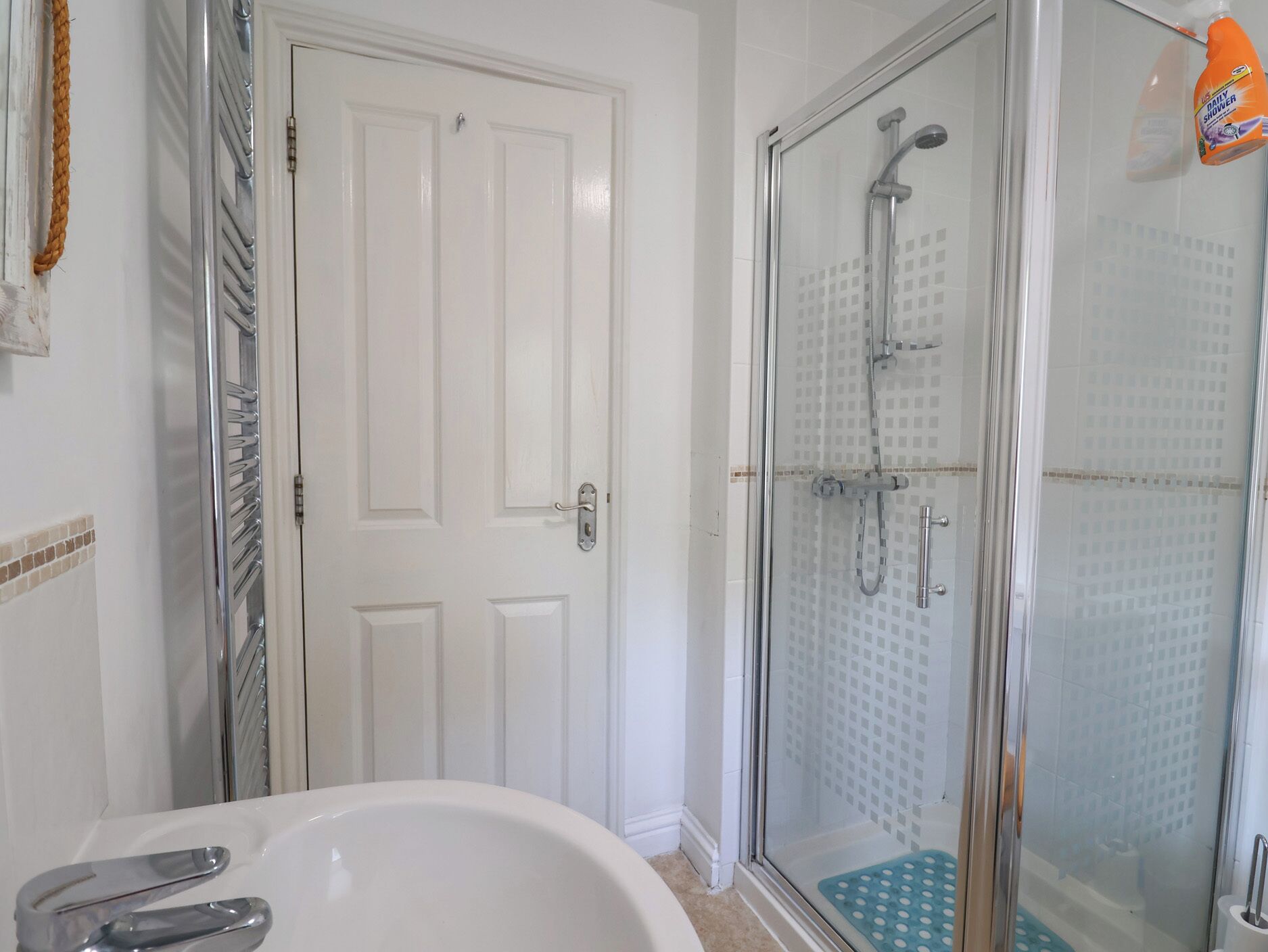 A bathroom with a shower, a bathtub, and a toilet.