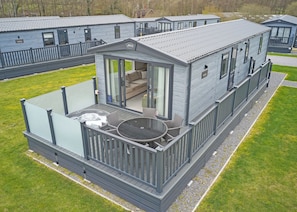 A mobile home with a balcony, a hot tub, and a patio area. - Premium 3 bed HT Pet (Landford, Nr Salisbury)