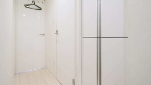 A hallway with a white door, a glass shower door, and a metal hanger on a track. - 6 minutes walk from Asakusa Sta. (Sumida City)