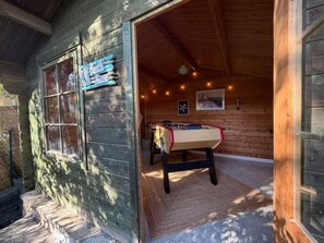A wooden building with a sign reading 'Beach House.' Inside, there is a foosball table and a small seating area with a rug. - Villa Jardin Azur - Pool - Gulf of St-Tropez (Roquebrune-sur-Argens)
