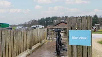 A wooden fence, a bike wash station, and a sign indicating 'Bike Wash'.