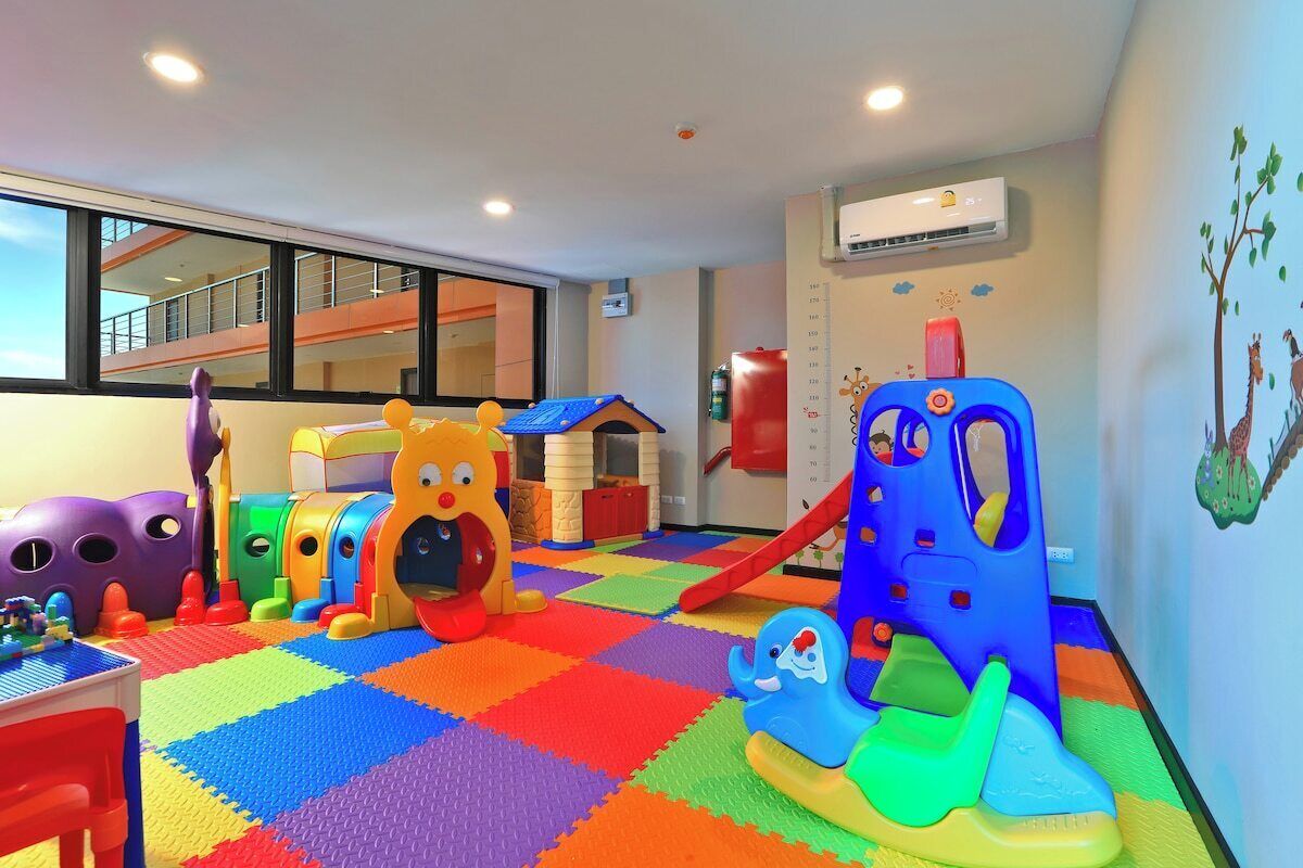 A play area with colorful play structures and a checkered floor.