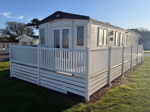 Exterior - All the home comforts of a Classic Holiday Home, plus a larger decking. Two bedroom holiday home sleeping 4 people; 1 double & 1 twin room. Lounge, dining table and chairs, fully equipped kitchen, shower room. (West Lulworth)