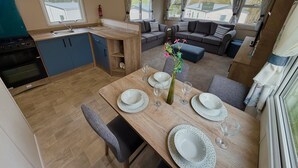 A compact living space with a kitchenette, dining area, and seating area.