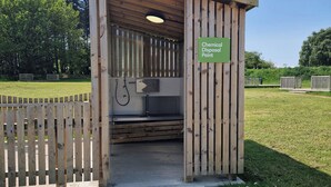A wooden structure labeled as a Chemical Disposal Point with a hose and a metal box. - Sherwood Pines - Deluxe Pod 3 (Mansfield)