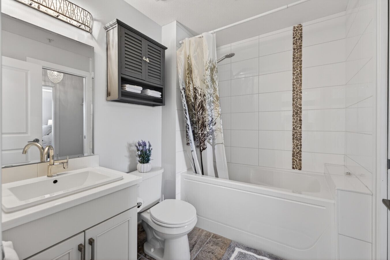 A bathroom with a white sink, toilet, and bathtub.