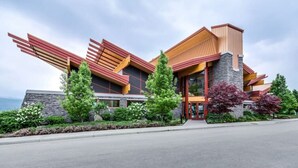 A modern building with a unique architectural design, featuring a mix of materials and a prominent entrance. - Bright 1 Bdrm at Amenity Rich Resort 102 (West Kelowna)