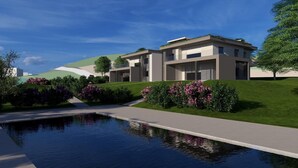 A modern residential building with a swimming pool, surrounded by well-maintained gardens and a clear sky. - Villa Aqua_Lydia Suite Apartment_Lake View & Pool (San Felice del Benaco)