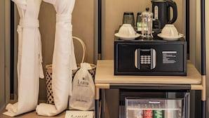 A hotel room with a wardrobe, a hair dryer, a coffee maker, and a minibar. - Lumi Hoi An Hotel (Da Nang)