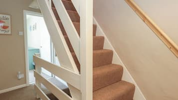 Eine Treppe mit weißer Handlauf und Teppichstufen.