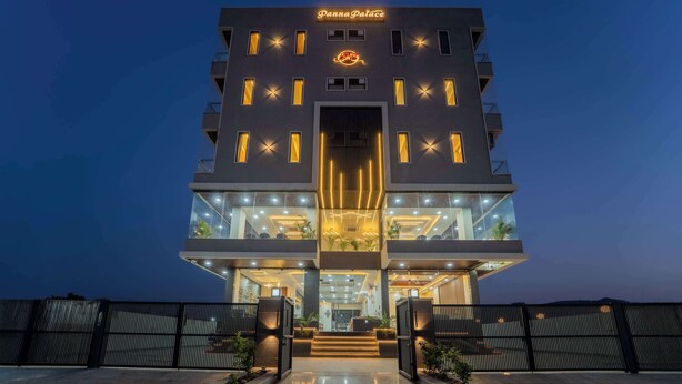 A modern hotel with a prominent sign, multiple windows, and a well-lit entrance. - Panna Palace-A Luxury Boutique Hotel (Amer)