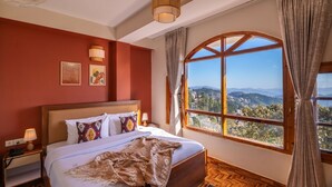 A bedroom with a large window, a bed, a nightstand, and a lamp. - PACK Shimla (Shimla)