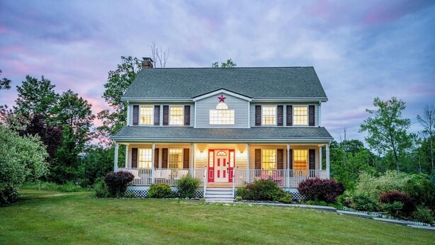A two-story house with a front porch, a red door, and a star decoration above the door. - Spacious Summer Oaisis 4-bedroom house with AC in Kerhonkson (Kerhonkson)