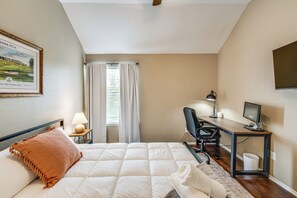 A hotel room with a bed, a desk with a computer, a chair, a lamp, and a framed picture on the wall. - 4 Mi to Toyota Stadium! Spacious Frisco Retreat (Frisco)