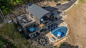 A multi-story building with a rooftop deck, a hot tub, and a swimming pool. - Summit Splendor | Steps to The Trillium, Indoor Pool, Playground, Views! (Sevierville)