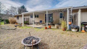 A covered patio area with a fire pit, outdoor seating, and potted plants. - Ocean City Home w/ Fenced Yard: 1 Mi to Beach! (Ocean Shores)