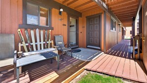 A wooden deck with a bench and skis leaning against the wall, a door, and a covered porch area. - Beaver Village Unit #0611 Renovated ground floor family unit clubhouse amenities (Winter Park)