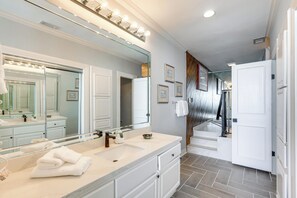 A bathroom with a large mirror, vanity, and a towel rack. - Penthouse w/ Beach Access: Suntide III - Unit 1101 (South Padre Island)