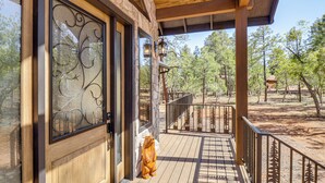 A wooden porch with a stone wall, a metal gate, and a wooden fence. - Spacious Family Gem w/ Patio, 3 Mi to Rainbow Lake (Lakeside)