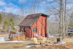 A log cabin with a deck, two chairs, and a wood stove. - Handcrafted Tiny Home, Near Dtwn Boone (Boone)