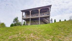 A two-story stone building with a balcony and stairs. - 2 Mi to Blue Ridge Pkwy! Mtn Escape w/ Fireplace (Meadows Of Dan)