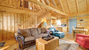 A wooden interior with a staircase, a sofa, a coffee table, and a dining area. - 2 Mi to Blue Ridge Pkwy! Mtn Escape w/ Fireplace (Meadows Of Dan)