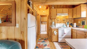 A wooden cabin interior with a kitchen, a refrigerator, a stove, and a laundry area. - 2 Mi to Blue Ridge Pkwy! Mtn Escape w/ Fireplace (Meadows Of Dan)