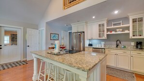 A kitchen with white cabinetry, a granite countertop, and a stainless steel refrigerator. - 'sunset Blue' Cabin Near Dale Hollow Lake (Byrdstown)