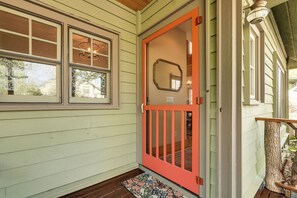 A house with a red door, a window with a decorative glass, and a wooden porch. - Close to Lake Glenville & Golf! Mtn-view Retreat (Cashiers)