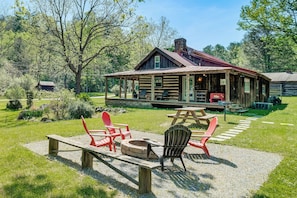 A rustic cabin with a covered porch, outdoor seating, and a fire pit. - Trout Stream Access! Rural Buchanan Cabin (Buchanan)