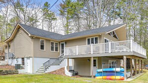 A two-story house with a balcony, a covered porch, and a garage. - A-frame Waterfront Escape on Lochada Lake (Glen Spey)