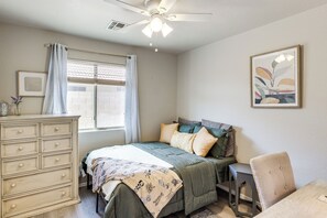 A bedroom with a bed, dresser, chair, and artwork on the wall. - Dedicated Office! Casa Grande Extended Stay (Casa Grande)