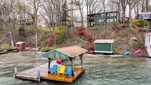 A dock with a covered seating area and a small building nearby. - Sunset Side of Seneca Lake! Family Home w/ Dock (Hector)