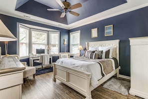 A bedroom with a bed, desk, chair, and a ceiling fan. - Families Welcome! Spacious Loganville Gem w/ Yard (Loganville)