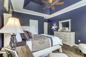 A bedroom with a bed, bedside tables, a ceiling fan, and a dresser. - Families Welcome! Spacious Loganville Gem w/ Yard (Loganville)