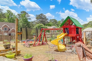 A playground with swings, slides, and a climbing structure. - Families Welcome! Spacious Loganville Gem w/ Yard (Loganville)