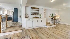 A spacious kitchen with white cabinets, a wooden countertop, and a hanging rack. - Waterfront Lake Marion Home w/ Dock: Fish & Boat! (Manning)
