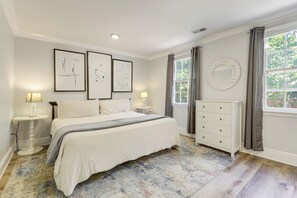 A bedroom with a bed, bedside tables, a dresser, a window with curtains, and framed artwork on the wall. - Waterfront Lake Marion Home w/ Dock: Fish & Boat! (Manning)