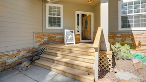 A house with a stone foundation, a wooden front porch with steps, and a door leading inside. - Game Room & On-site Golf Course! Lake Almanor Home (Westwood)