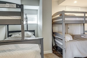 A bunk bed room with a window, a door, and a wall-mounted sign. - Private Dock & Large Deck! Jimmerson Lake Escape (Angola)