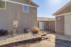 A residential house with a front yard, a driveway, and a garage. - Private Dock & Large Deck! Jimmerson Lake Escape (Angola)