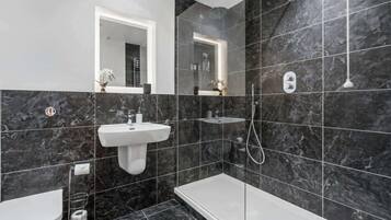 Shower, hair dryer, towels, shampoo