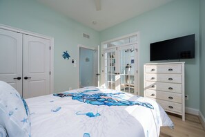 A bedroom with a bed, a dresser, a television, and a door. - Beautiful Single Family Home With Tons Of Amenities! (Rehoboth Beach)