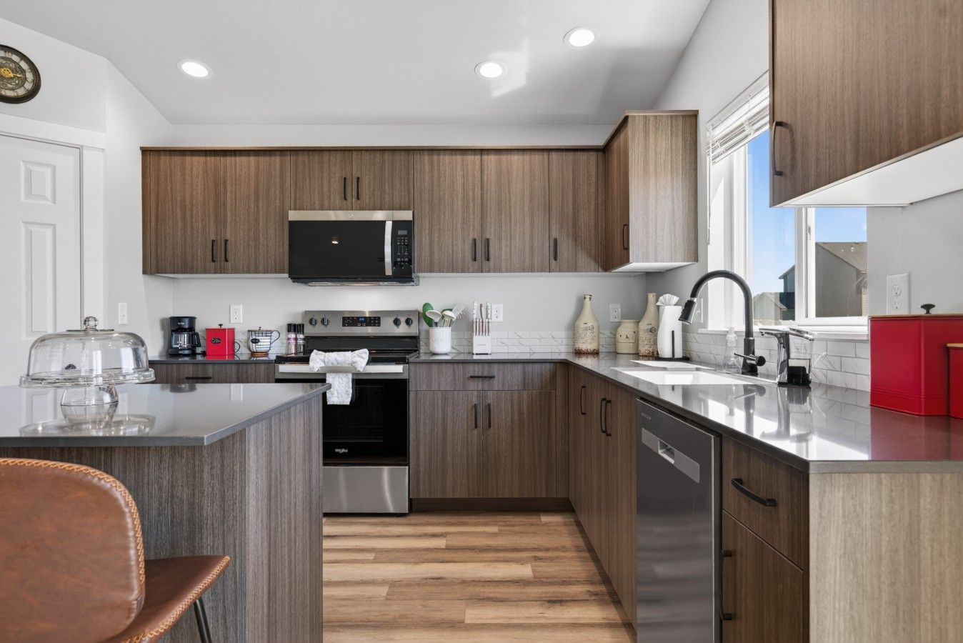 A modern kitchen with wooden cabinets, stainless steel appliances, and a central island.