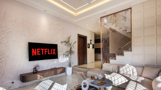 A modern living room with a flat-screen TV, a sofa, a coffee table, and a staircase. - ELIVAAS Shourya Villa 3-BHK Villa (Udaipur)
