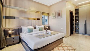 A modern bedroom with a large bed, bedside tables, a wardrobe, and a mirror. - ELIVAAS Shourya Villa 3-BHK Villa (Udaipur)