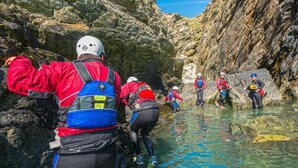 A group of people in a rocky canyon with clear water. - Spacious Four Bedroom Holiday Accommodation On Anglesey | Bryndeusant (Holyhead, Ynys Môn)