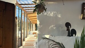 Ein Zimmer mit einer Holztreppe, weißen Wänden und einer hängenden Pflanze.