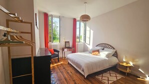 A bedroom with a bed, dresser, chair, and a window with curtains. - Libourne near Saint-Émilion, Villa Beauséjour (Libourne)