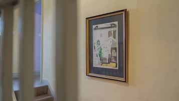 A hallway with a framed artwork on the wall.
